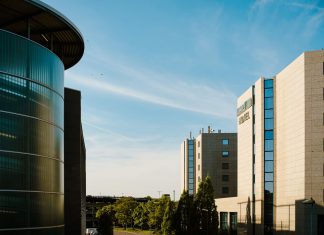 Contemporary hotel architecture with blue sky backdrop in city environment.