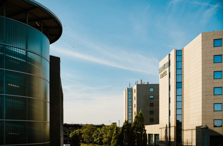 Contemporary hotel architecture with blue sky backdrop in city environment.