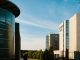 Contemporary hotel architecture with blue sky backdrop in city environment.