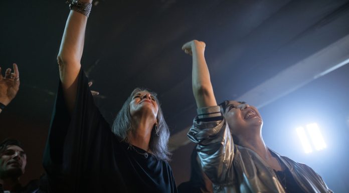 Queer Comedy at Art House: A Warm, Winning Night in Jersey City Vibrant party scene with diverse friends dancing and raising hands at a club.