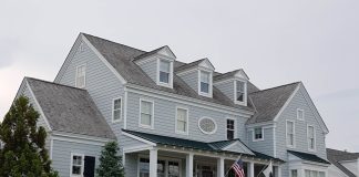 Real Estate Newark 2026: Market Trends, Prices & What Buyers Should Know Elegant colonial-style house in Cape May, NJ with manicured lawn and American flags.