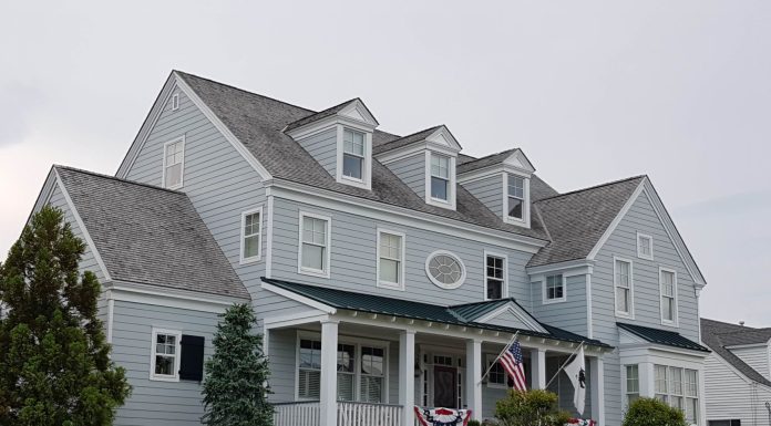 Real Estate Newark 2026: Market Trends, Prices & What Buyers Should Know Elegant colonial-style house in Cape May, NJ with manicured lawn and American flags.