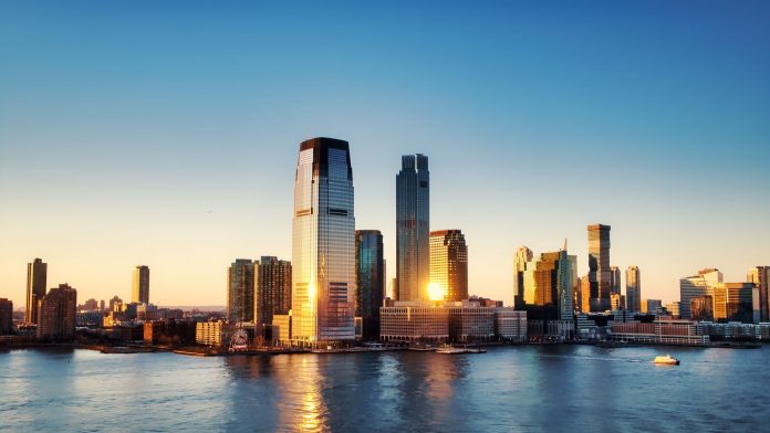 rent-cost-union-city-2026 Breathtaking sunrise view over New York City skyline with reflection on the water.
