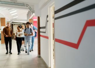 Stevens Taps Brendan Englot as Interim Dean for New School of Computing A diverse group of teenagers walking together in a modern school hallway.