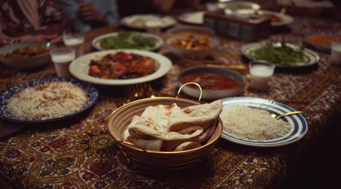 The Canteen: A South Asian Supper Club in Jersey City A vibrant spread of Indian dishes on a colorful tablecloth, perfect for culinary themes.