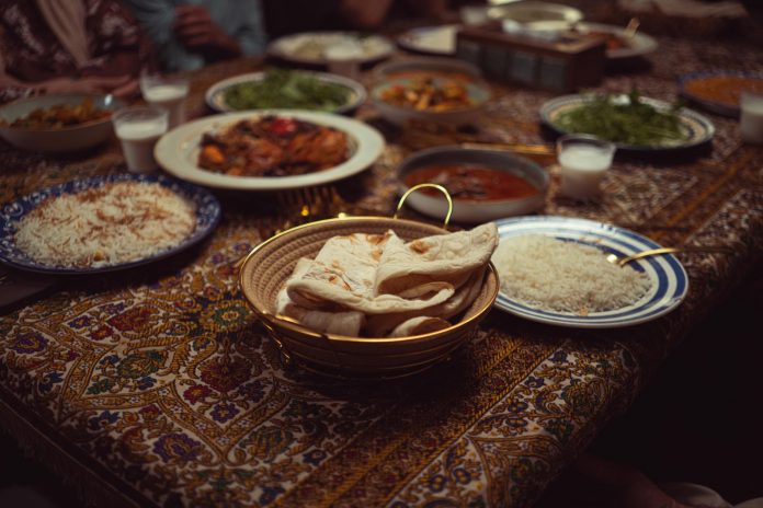 the-canteen-a-south-asian-supper-club-in-jersey-ci A vibrant spread of Indian dishes on a colorful tablecloth, perfect for culinary themes.