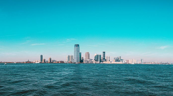 Panoramic view of Manhattan skyline with modern skyscrapers under a clear blue sky.