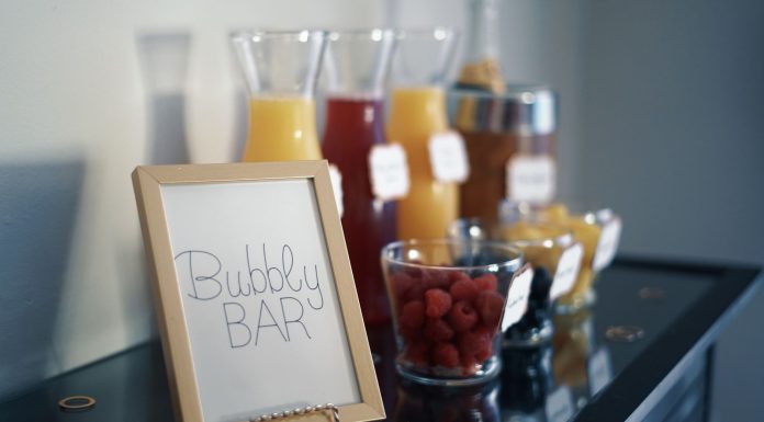 8th Street Tavern Kicks Off Fall With Brunch Bingo, New Menu A sophisticated bubbly bar arrangement featuring juices, fresh raspberries, and an inviting sign.