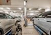 Interior of an automotive repair shop with cars undergoing maintenance and servicing.