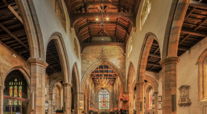 A beautifully detailed view of the nave inside a historic English church, showcasing gothic architecture.