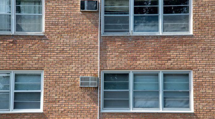 BREAKING: 100-Unit Paterson Apartment Complex Sold Close-up of a brick apartment facade featuring multiple modern aluminum windows.
