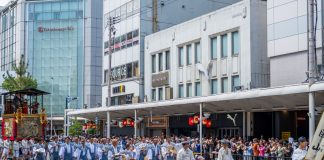 Traditional Gion Festival parade in Kyoto with participants in traditional attire.