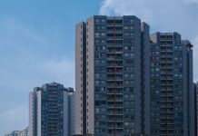 BREAKING: Casa One Debuts 196 Rentals in Jersey City’s Journal Square Tall city skyscrapers with multiple windows against a clear blue sky, epitomizing urban architecture.