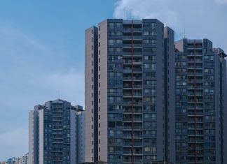 BREAKING: Casa One Debuts 196 Rentals in Jersey City’s Journal Square Tall city skyscrapers with multiple windows against a clear blue sky, epitomizing urban architecture.