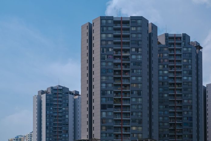 breaking-casa-one-debuts-196-rentals-in-jersey-cit Tall city skyscrapers with multiple windows against a clear blue sky, epitomizing urban architecture.