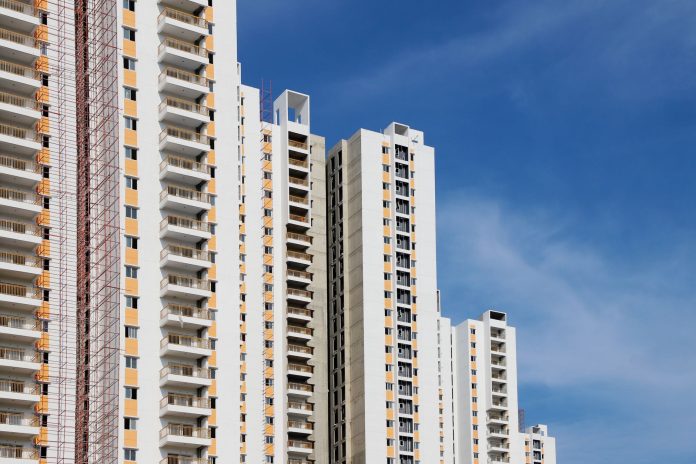 breaking-elizabeth-ave-tower-near-newark-gets-70m- Modern high-rise residential buildings with white facades and blue sky backdrop showcasing urban architecture.