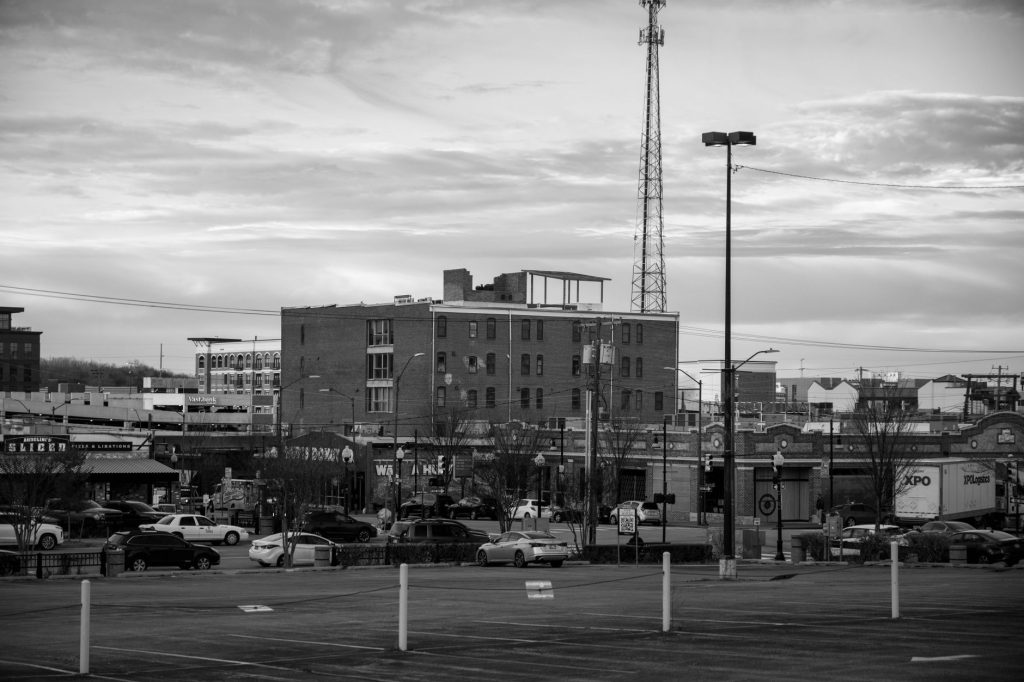 Black and white view of an urban cityscape in Tulsa, Oklahoma featuring buildings and parking lots.