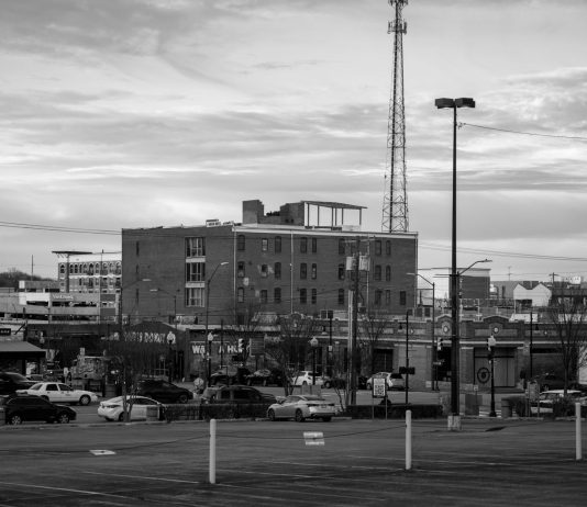 Black and white view of an urban cityscape in Tulsa, Oklahoma featuring buildings and parking lots.