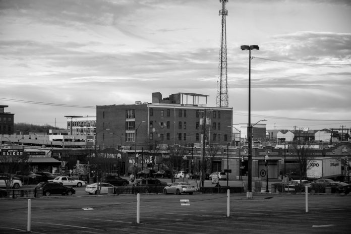 Black and white view of an urban cityscape in Tulsa, Oklahoma featuring buildings and parking lots.