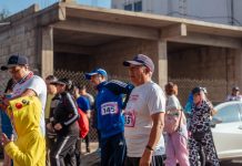 Participants engage in a vibrant marathon event, showcasing diverse attire and lively atmosphere.