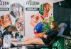 Tattoo artist creating detailed art in a vibrant studio setting.