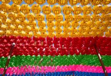 Colorful lanterns hang in vibrant rows, creating a festive atmosphere.