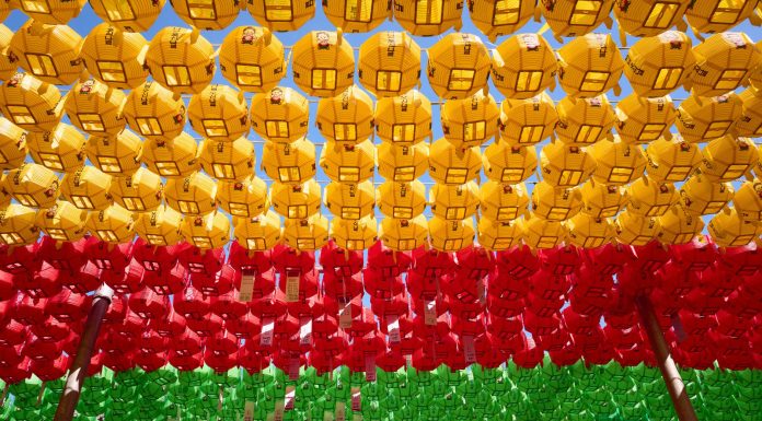 Colorful lanterns hang in vibrant rows, creating a festive atmosphere.