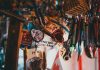 A colorful array of souvenir keychains and pens hanging in a shop.