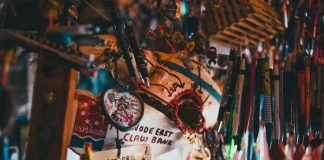 A colorful array of souvenir keychains and pens hanging in a shop.
