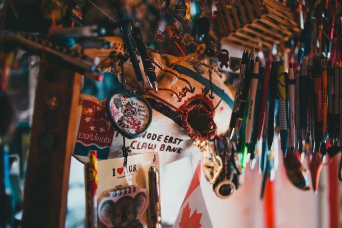 A colorful array of souvenir keychains and pens hanging in a shop.