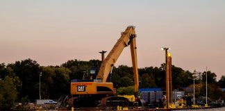 BREAKING: Passaic River Cleanup Moves To In-River Construction An excavator on a barge near Cove Island Park Marina during twilight in Stamford, Connecticut.