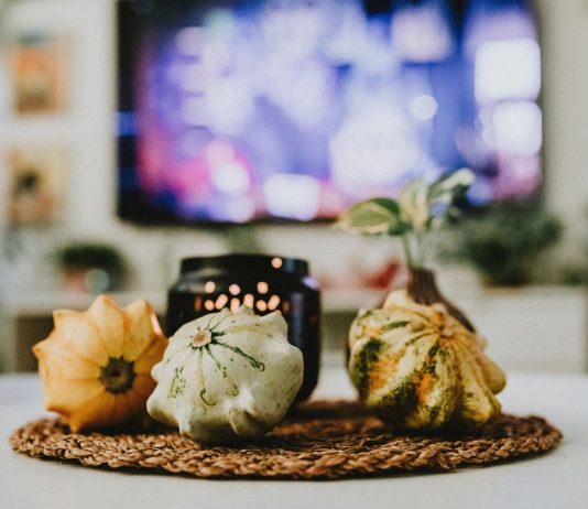 Fall Home Refresh: Meet the Jersey City Designer Behind Narine + Co. Stylish autumn decoration with pumpkins and candles in a cozy living room setting.