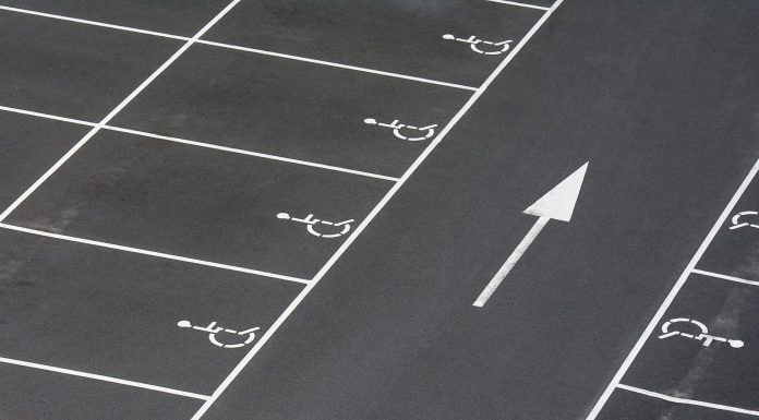 Hoboken opens 60 temporary parking spots in North End A clean parking lot featuring multiple handicapped spaces and a directional arrow marking.
