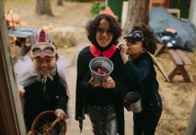 Hoboken’s Ragamuffin Parade Returns Oct. 31, Bigger Than Ever Three children in Halloween costumes joyfully trick-or-treating with candy buckets.