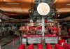 Hoboken’s West Side to Get 15-Restaurant Food Hall by 2027 Active Asian market scene showcasing an indoor butcher stall with various meat cuts and vibrant red seating.