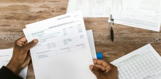 Jersey City’s Painful Budget: 15% Tax Hike, But Why It Could’ve Been Worse Hands holding financial papers for tax preparation and analysis.