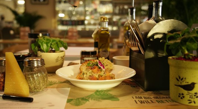 Delicious pasta dish with herbs in a warm restaurant ambiance, ideal for food lovers.