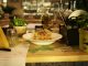 Delicious pasta dish with herbs in a warm restaurant ambiance, ideal for food lovers.