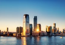 Living in Jersey City Pros and Cons: A 2026 Local’s Guide for Hudson County Breathtaking sunrise view over New York City skyline with reflection on the water.