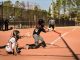 A dynamic moment during a women's softball game with the batter hitting the ball.