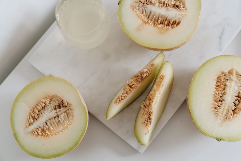 Delicious sliced melon resting on a smooth marble surface, highlighting freshness and nutrition.