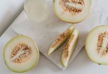 Delicious sliced melon resting on a smooth marble surface, highlighting freshness and nutrition.