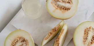 Delicious sliced melon resting on a smooth marble surface, highlighting freshness and nutrition.