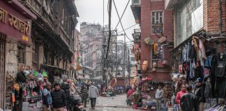 Street view of a lively market in Kathmandu, Nepal with vendors and shoppers.