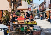 Vibrant street market scene with a fruit vendor in Cartagena, Colombia's historic district.