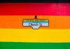 Vibrant Church Street sign in Toronto's Church-Wellesley Village with rainbow colors.