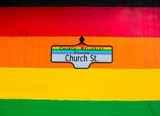 Las Mejores Iglesias en North Bergen: Guía Comunitaria para 2026 Vibrant Church Street sign in Toronto's Church-Wellesley Village with rainbow colors.