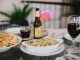 Los Mejores Restaurantes en Union City en 2026: Guía Definitiva de Sabor Local An inviting dining setup featuring tacos, chips, beer, and wine on a glass table in a relaxed indoor setting.