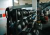 Well-equipped indoor gym featuring kettlebells, weights, and workout gear, perfect for fitness enthusiasts.
