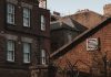 An old urban scene showcasing brick buildings with a vintage charm and architectural details.